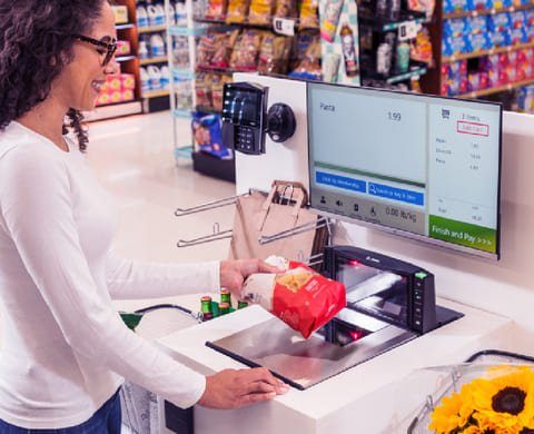 Colleague weighing fresh items on a self-service scale